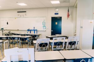 Empty classroom with desks and chairs in a school setting, representing indoor spaces where children learn and spend time.
