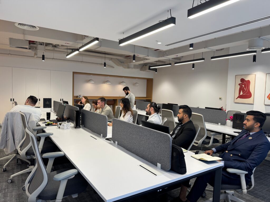 Employees working at desks in an open-plan office where indoor air quality affects focus and productivity
