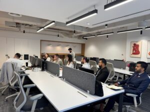 Employees working at desks in an open-plan office where indoor air quality affects focus and productivity