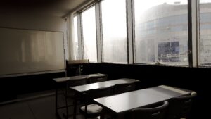 Sunlight shining into an empty classroom, highlighting the need for True HEPA filtration in schools to improve indoor air quality.