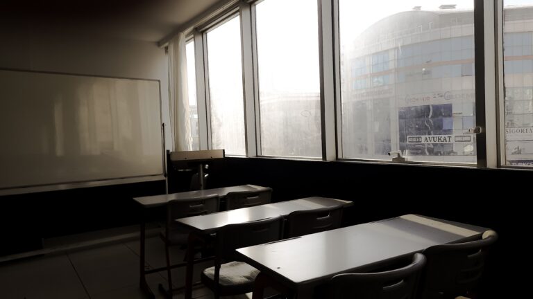 Sunlight shining into an empty classroom, highlighting the need for True HEPA filtration in schools to improve indoor air quality.