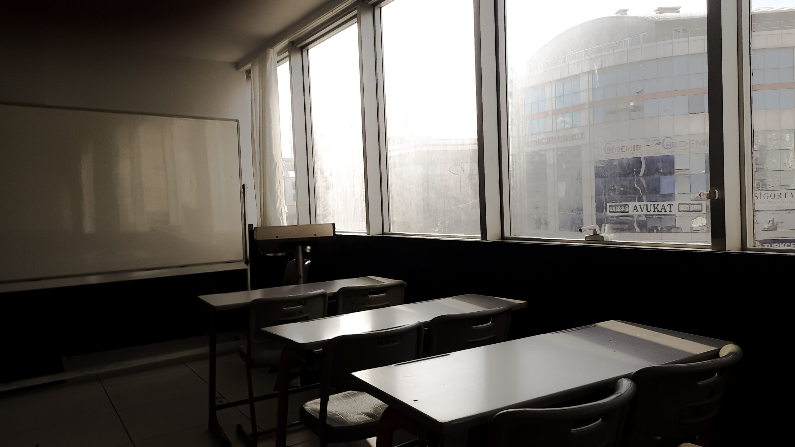 Sunlight shining into an empty classroom, highlighting the need for True HEPA filtration in schools to improve indoor air quality.