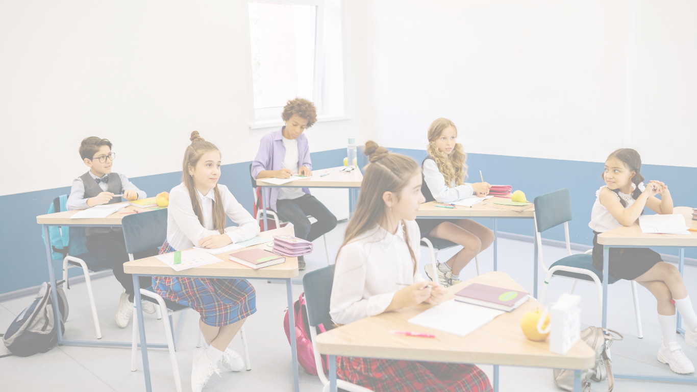 Students working at desks in a bright classroom