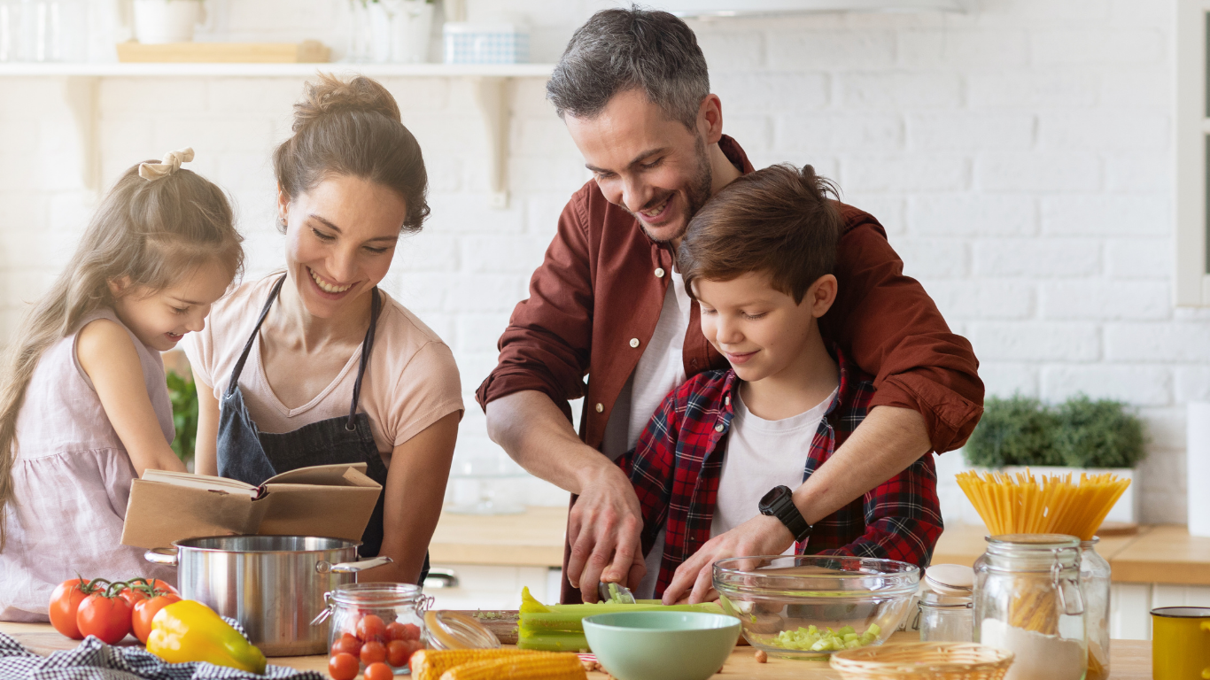 Family cooking together in a bright kitchen